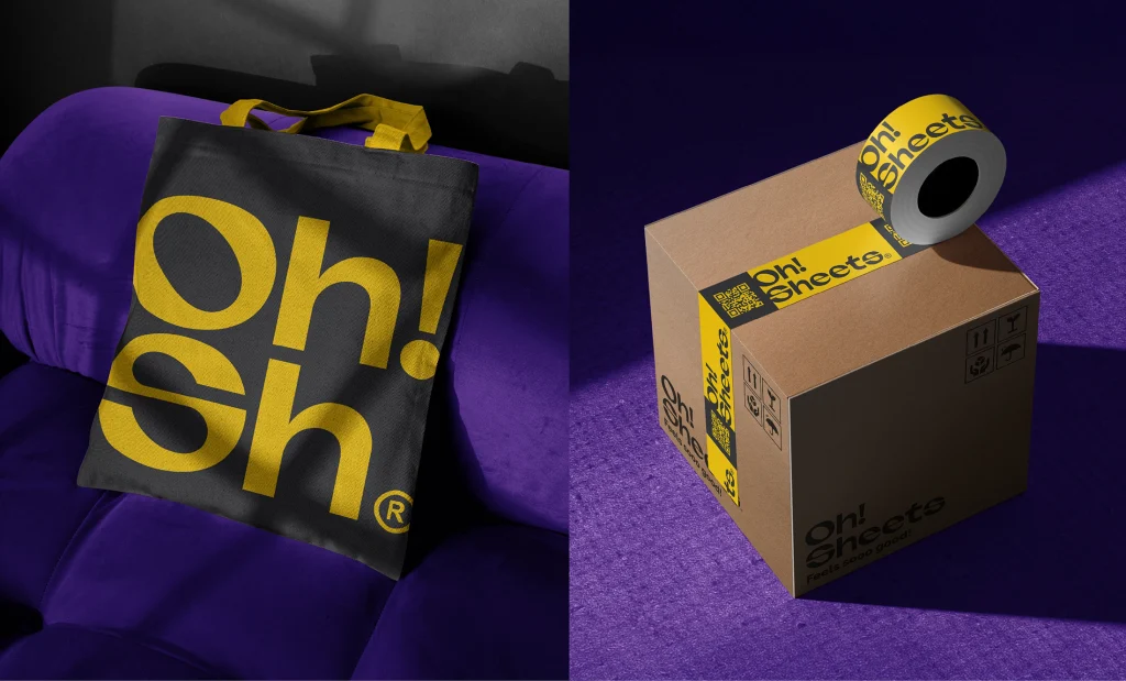 Tote bag y materiales promocionales de Oh! Sheets con tipografía de gran formato en amarillo y negro.